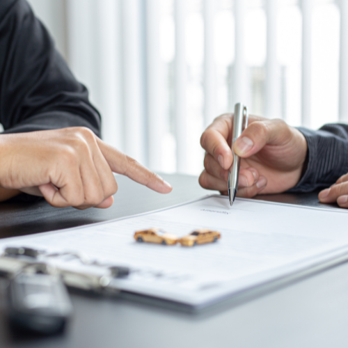 Insurance brokers signing a form.