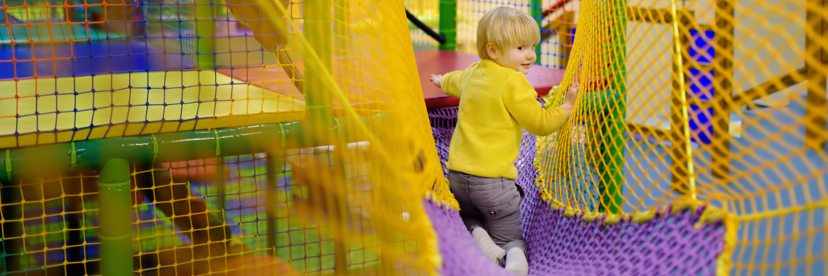 Young child playing in an insured indoor play centre.