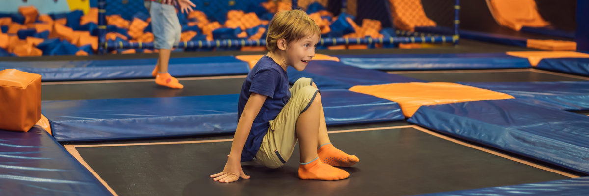Young child playing in an insured trampoline park.