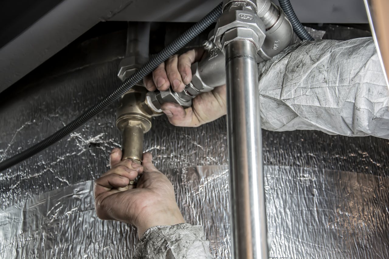property insurance plumber fixing pipe