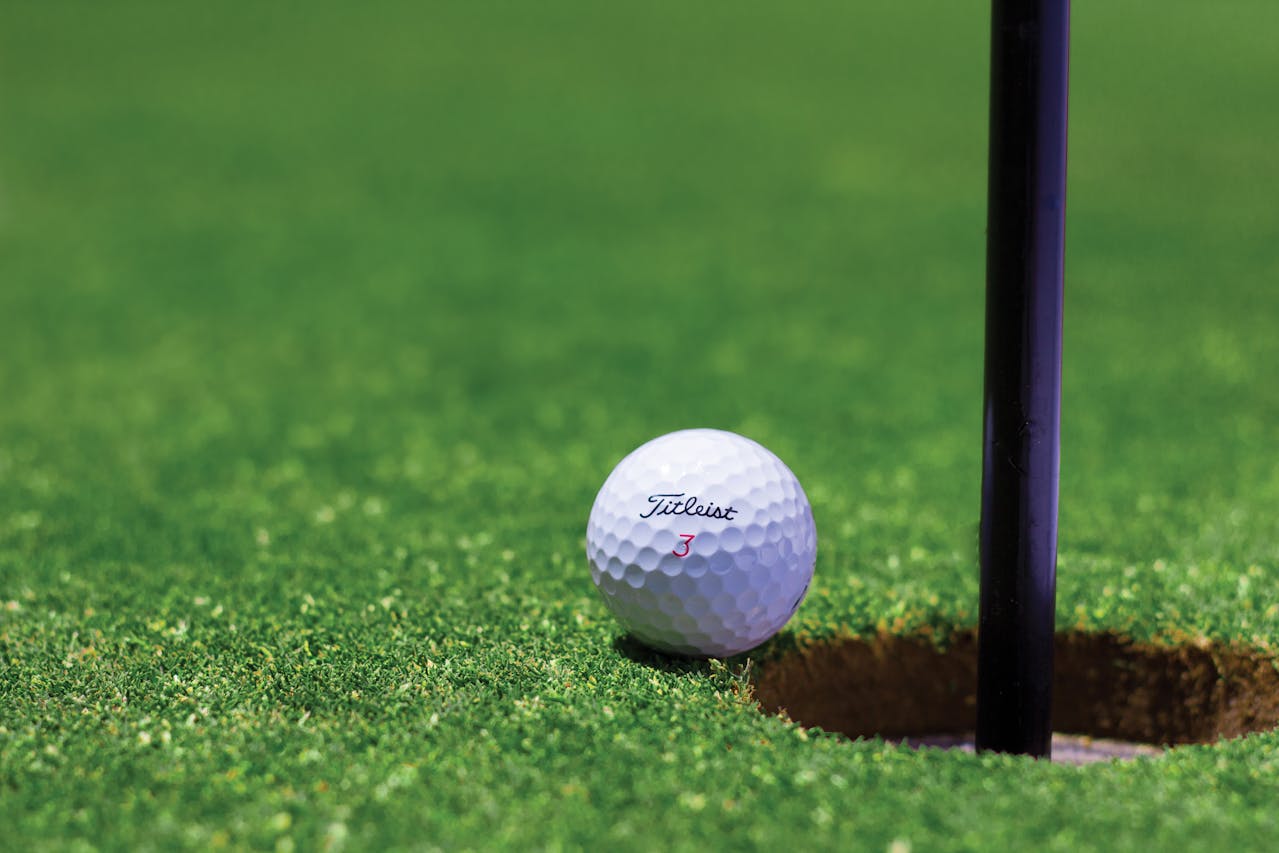 golf_course golf ball on the edge of the hole.