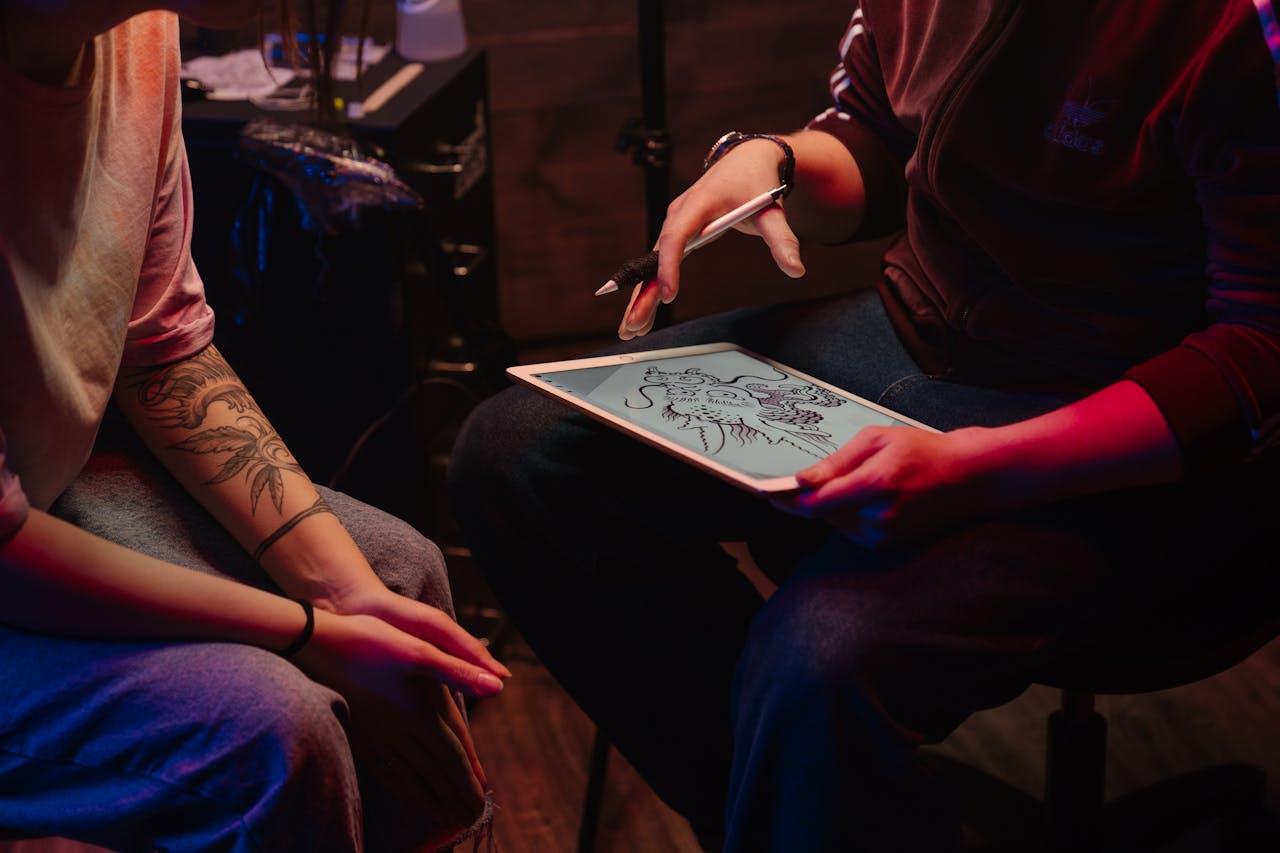 Tattoo insurance tattoo artist designing a tattoo