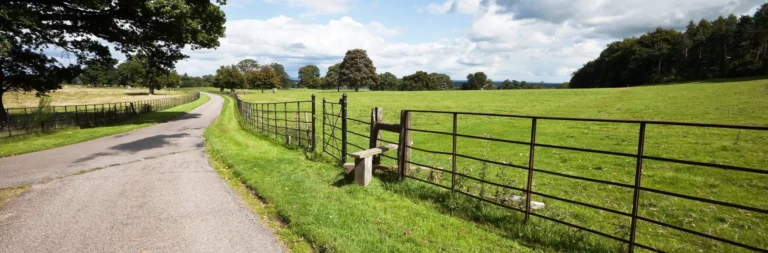 Private lane beside fenced pasture on low risk rural land