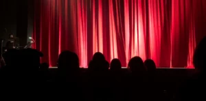 Events venue for a show with red curtains
